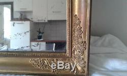 Miroir style Restauration XIXème au mercure cadre sculpté en bois doré