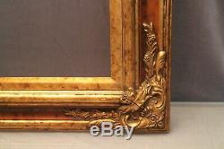 Très grand cadre en bois double patine acajou et or de style Louis XV